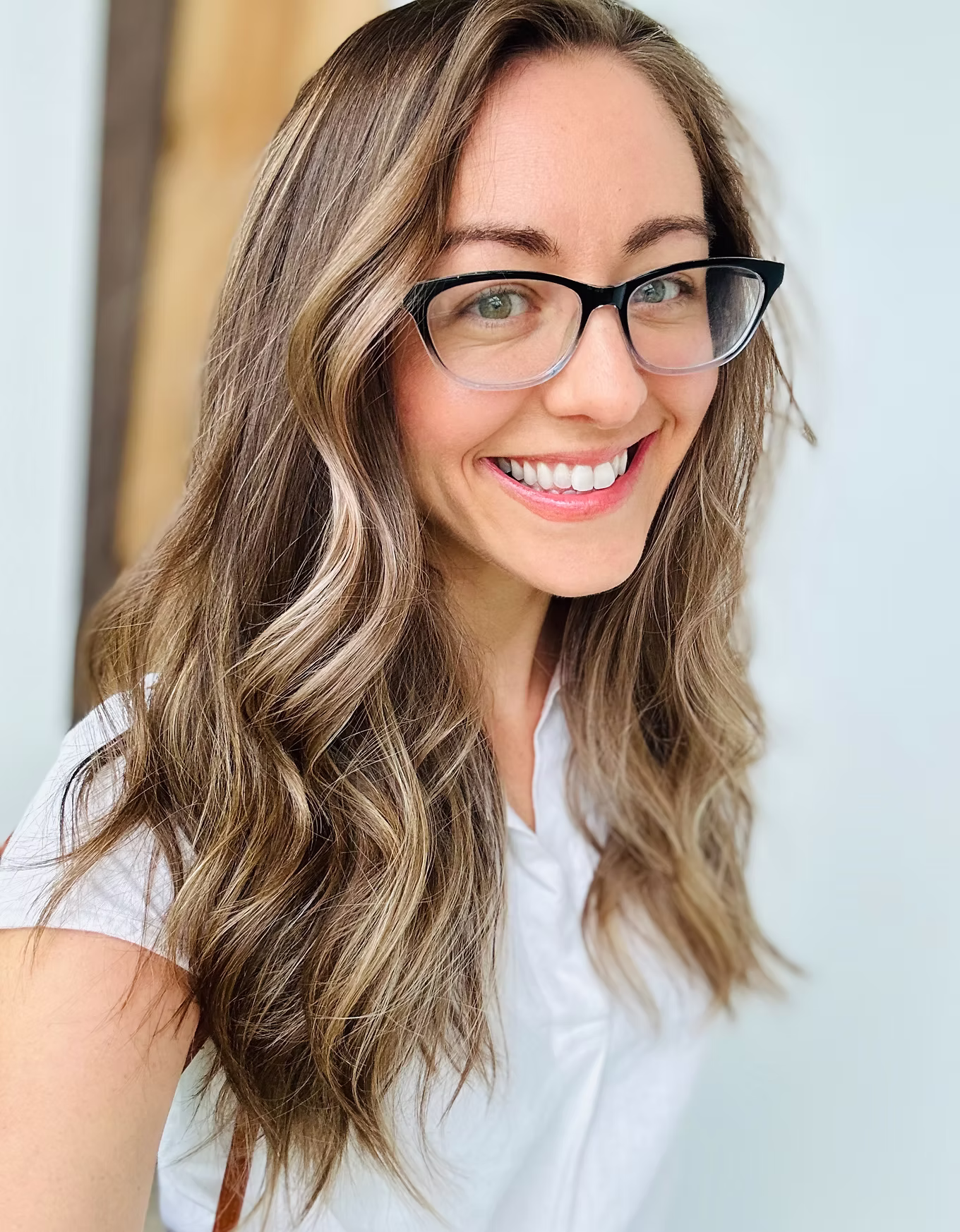 Candace, a therapist, seated in her office in a green cardigan.